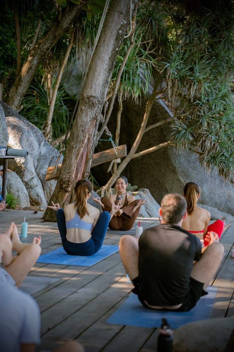 Group meditation session on the deck surrounded by nature