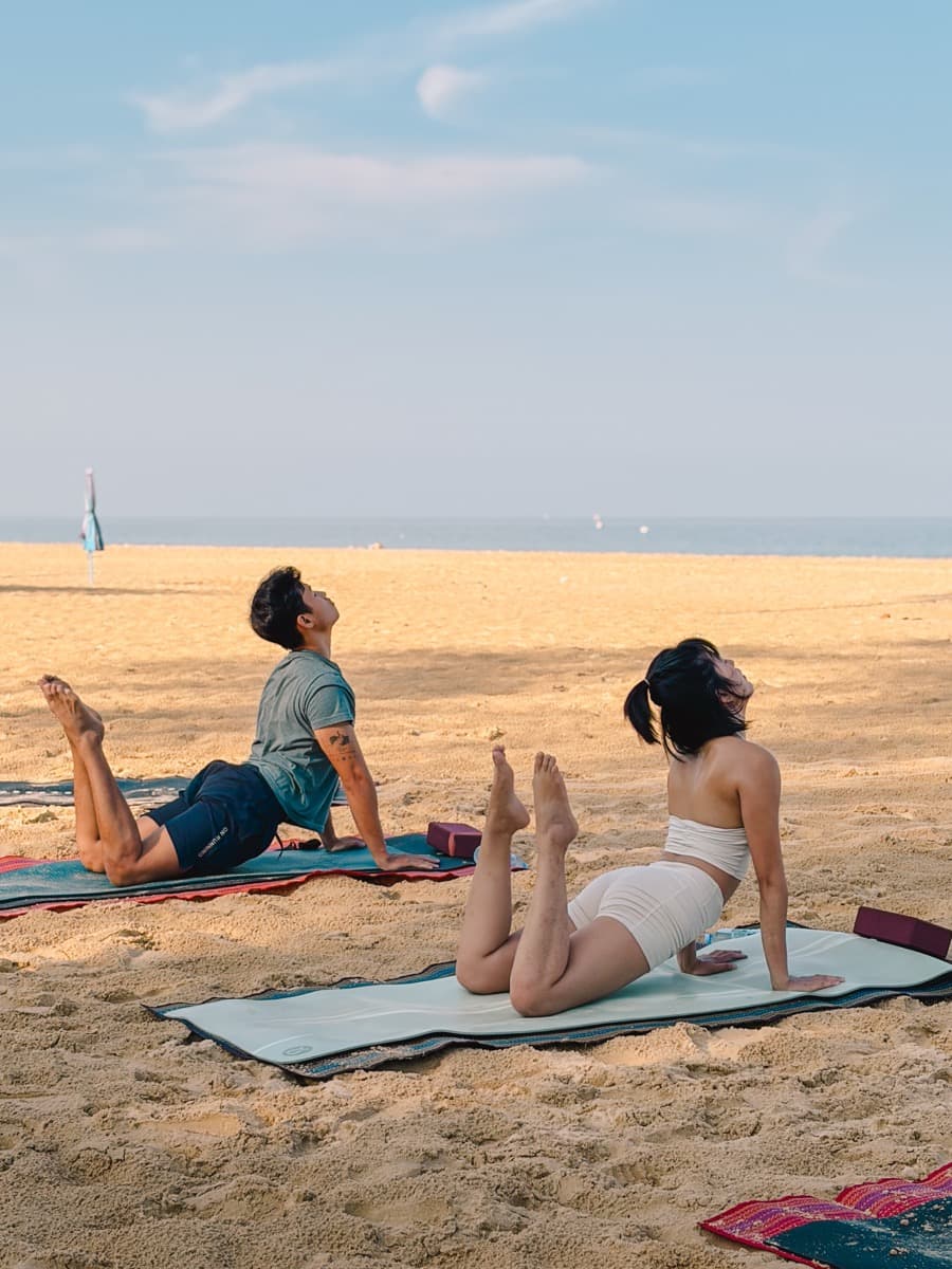 Beach yoga practice by the ocean